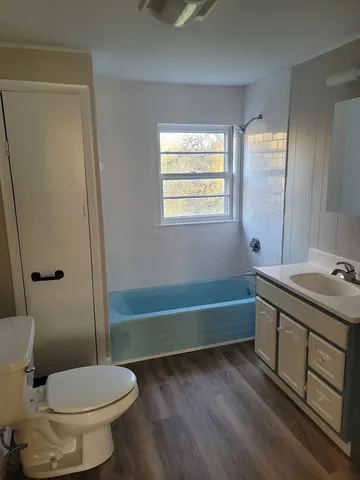 a bathroom with a sink a toilet and tub