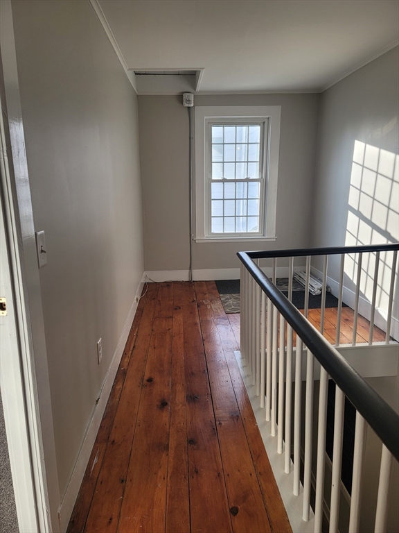 45 Main Street, Unit I Charlton, MA 01507 - Photo 9 of 11 a view of a hallway with wooden floor and staircase