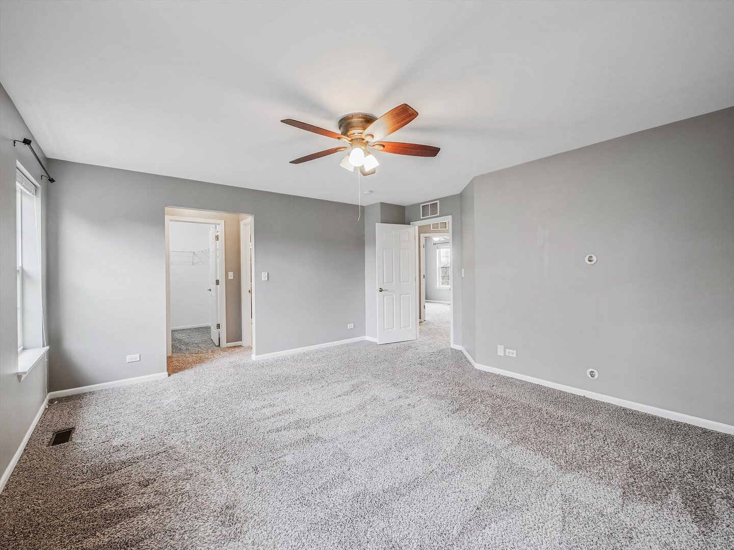 1090 Maubert Court Carol Stream, IL 60188 - Photo 28 of 55 a view of a room with a ceiling fan and a window