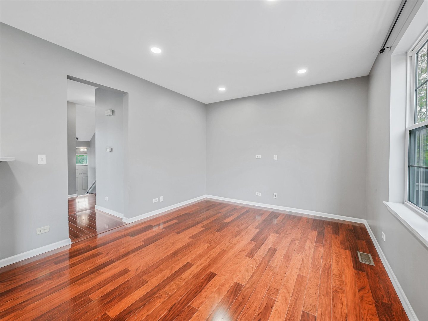 1090 Maubert Court Carol Stream, IL 60188 - Photo 10 of 55 a view of empty room with wooden floor and fan