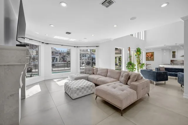 a kitchen with stainless steel appliances granite countertop a sink a stove and a refrigerator