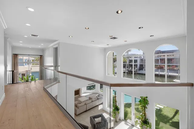 a view of a swimming pool with chairs in front of house