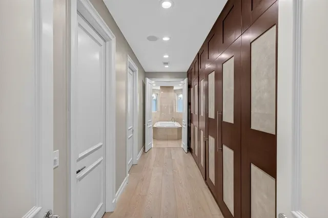 a bedroom with a large bed and a chandelier