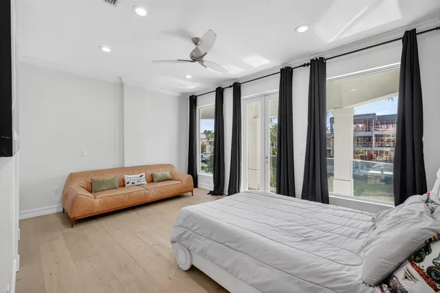 a bedroom with a large bed and a large window