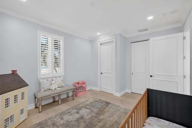 a living room with patio furniture and a garden
