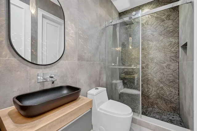 a view of a house with a yard and potted plants