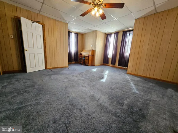 an empty room with closet and chandelier fan