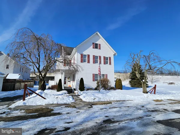 a view of a white house with a yard