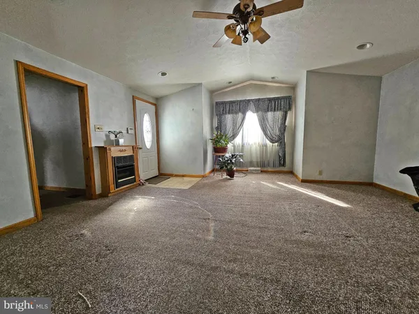 a view of a livingroom with furniture and a window