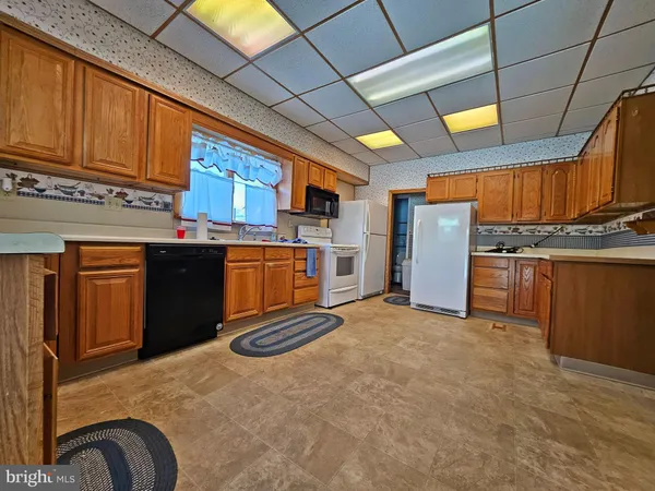 a view of kitchen with refrigerator and window