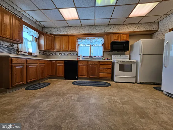 a kitchen with stainless steel appliances granite countertop a stove a sink dishwasher and a refrigerator