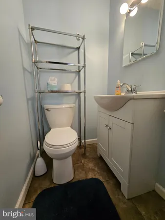 a bathroom with a toilet a sink and mirror