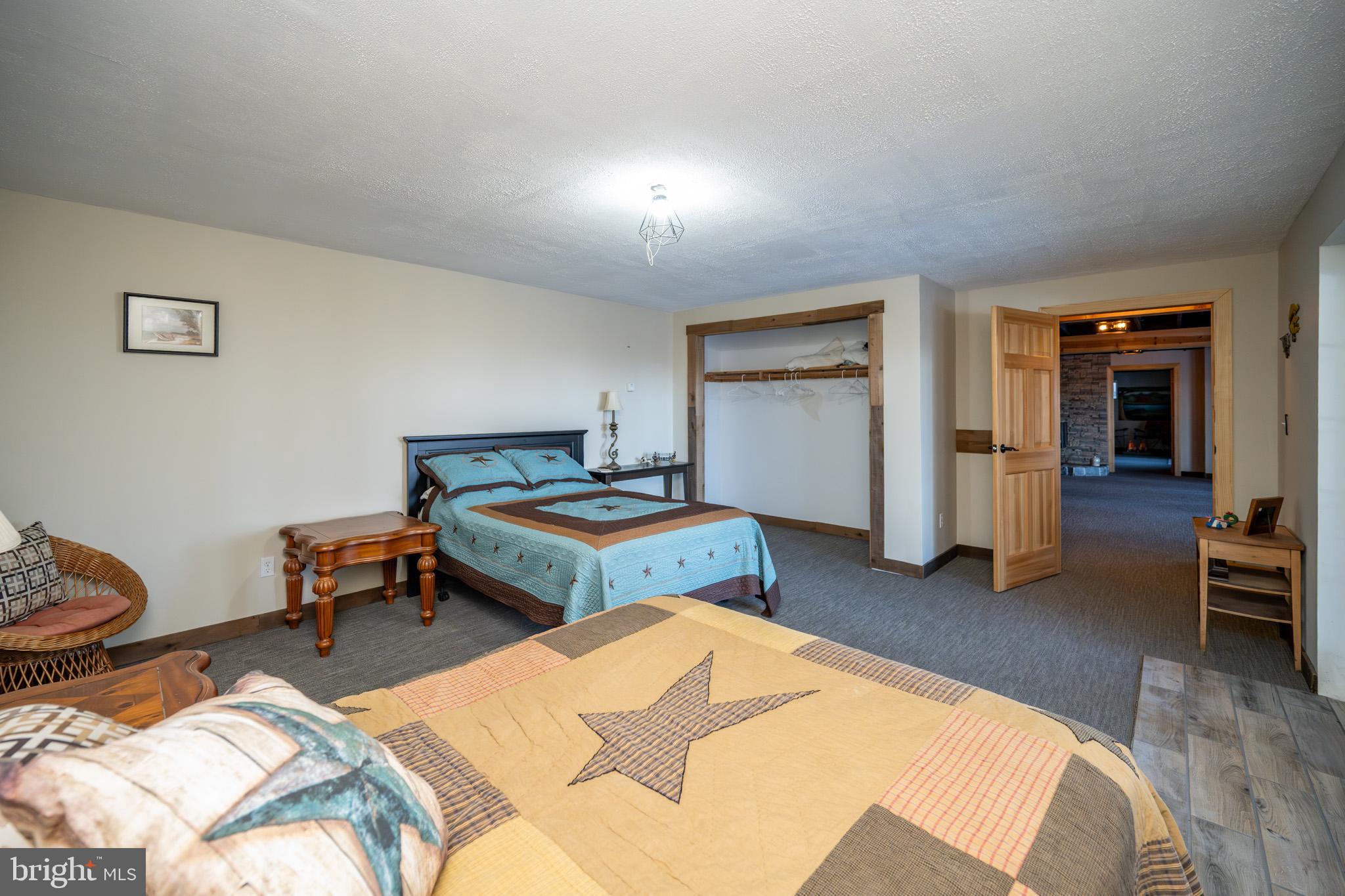 3836 Chestnut Grove Road Swanton, MD 21561 - Photo 109 of 111 a bedroom with a bed and wooden floor