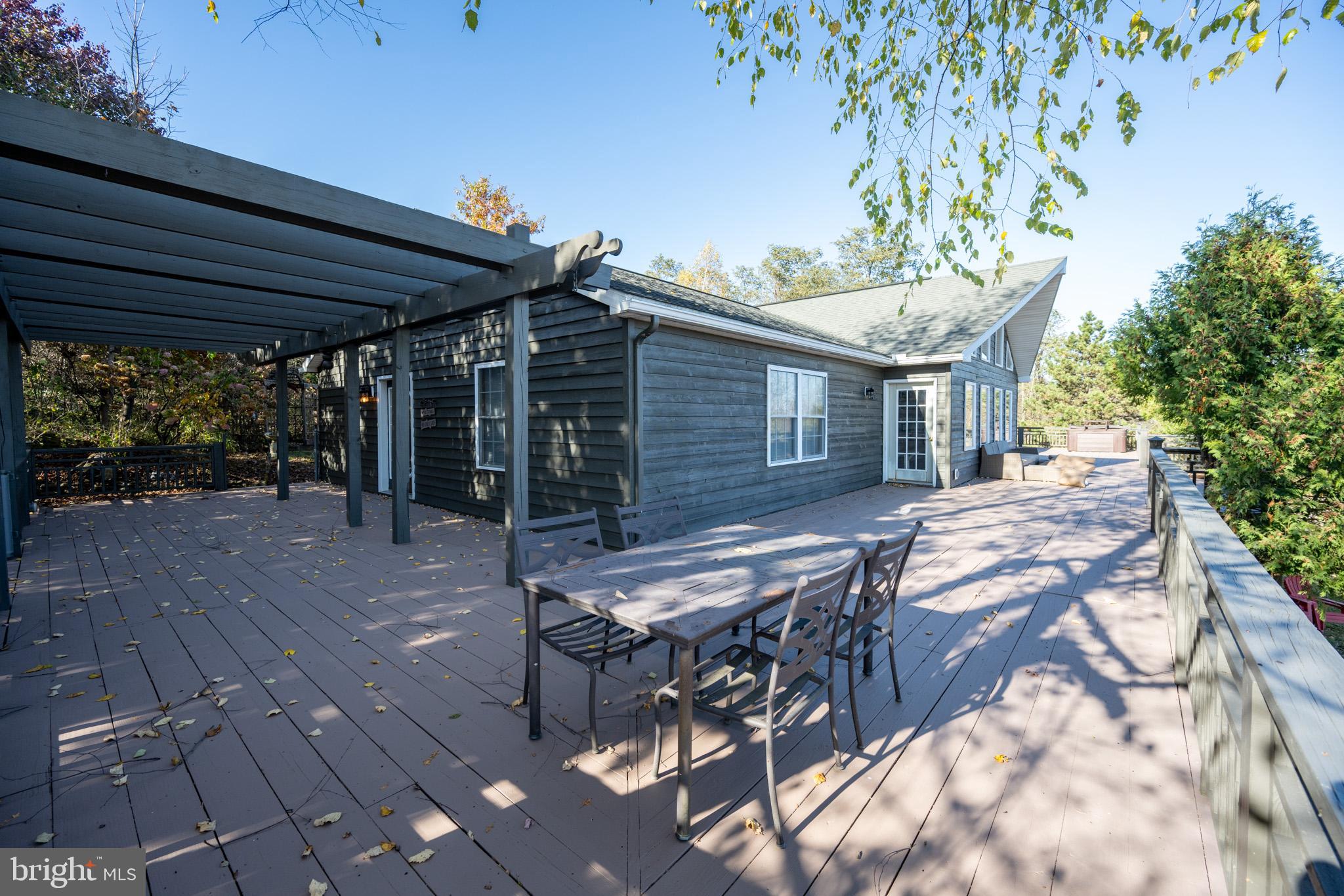 3836 Chestnut Grove Road Swanton, MD 21561 - Photo 34 of 111 a patio with table and chairs and potted plants