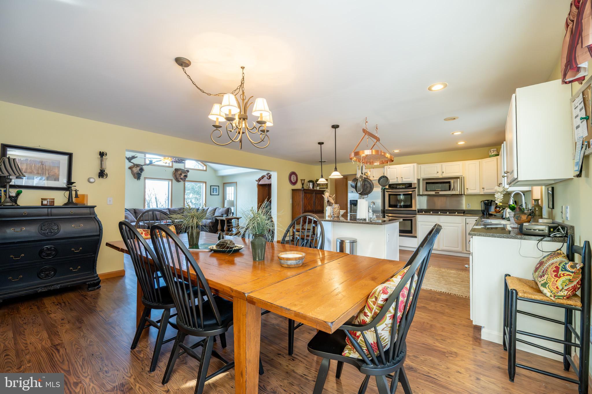 3836 Chestnut Grove Road Swanton, MD 21561 - Photo 66 of 111 a view of a dining room with furniture and wooden floor