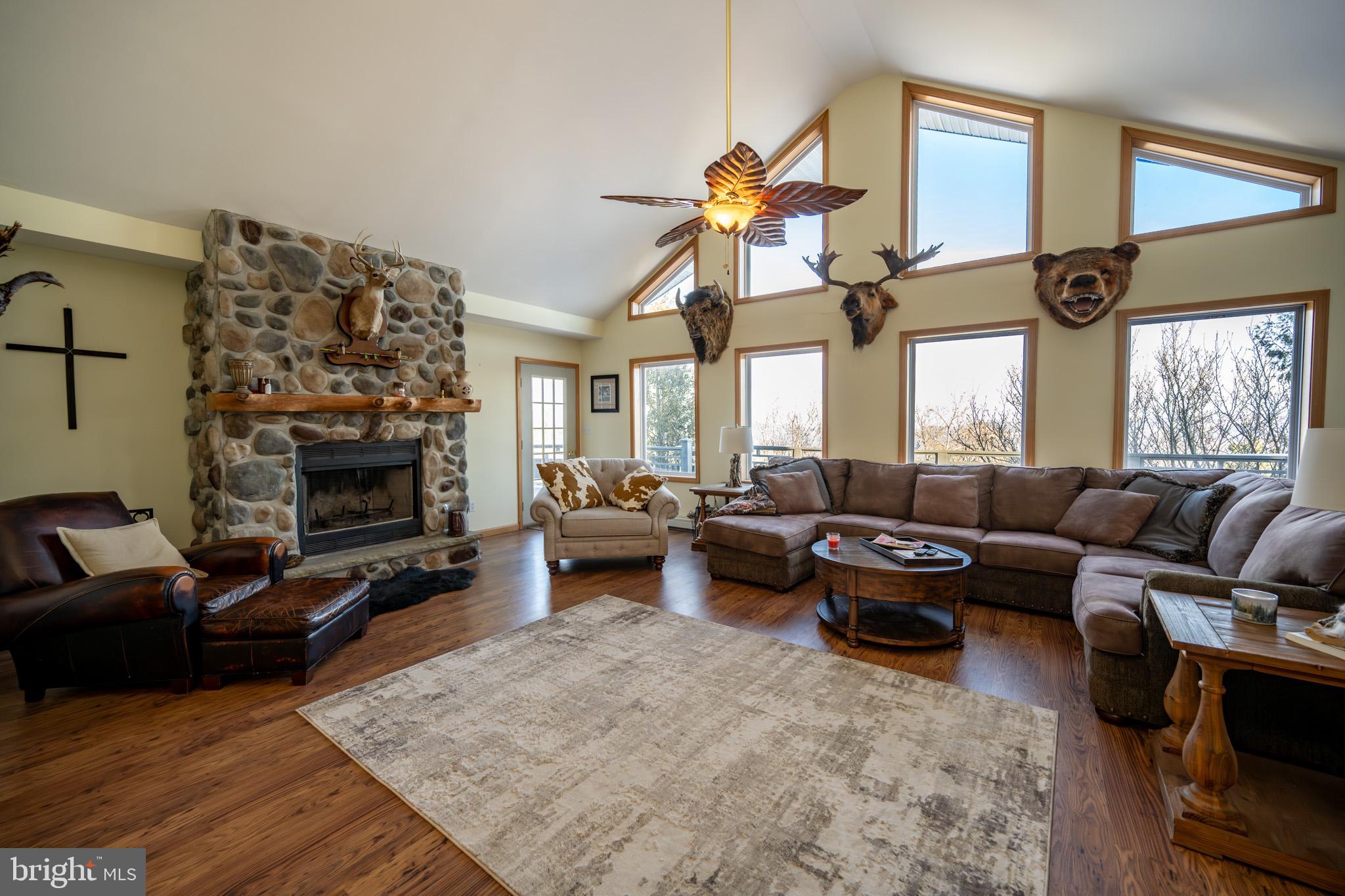 3836 Chestnut Grove Road Swanton, MD 21561 - Photo 68 of 111 a living room with furniture a fireplace and a flat screen tv