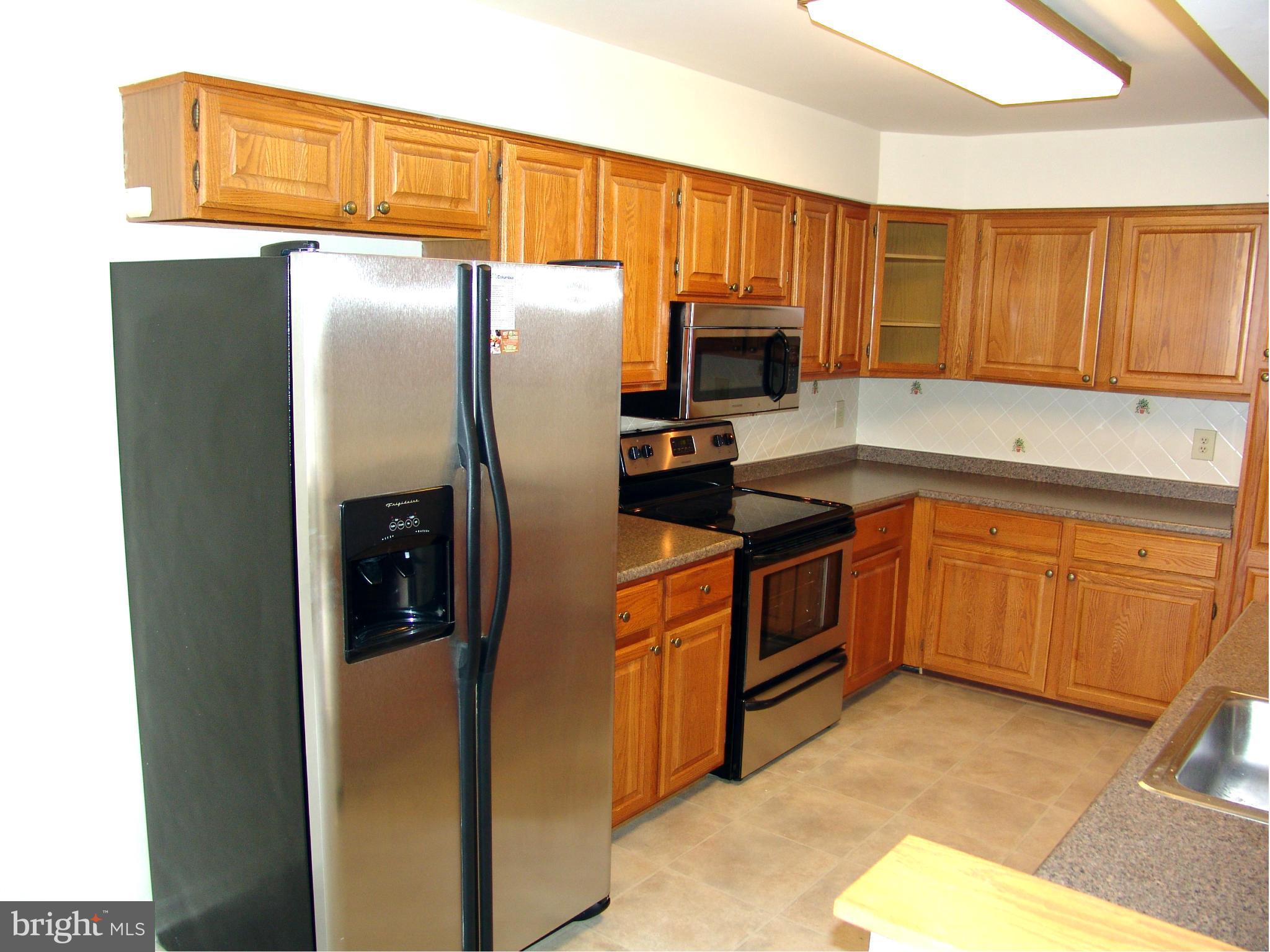 5223 Columbia Road, Unit 763 Columbia, MD 21044 - Photo 2 of 18 a kitchen with a refrigerator sink and cabinets