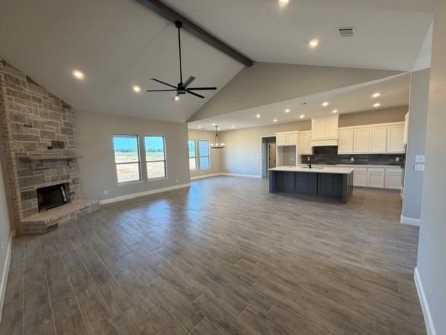 230 Kilkenny Road Poolville, TX 76487 - Photo 5 of 22 an open kitchen view with fireplace and wooden floor