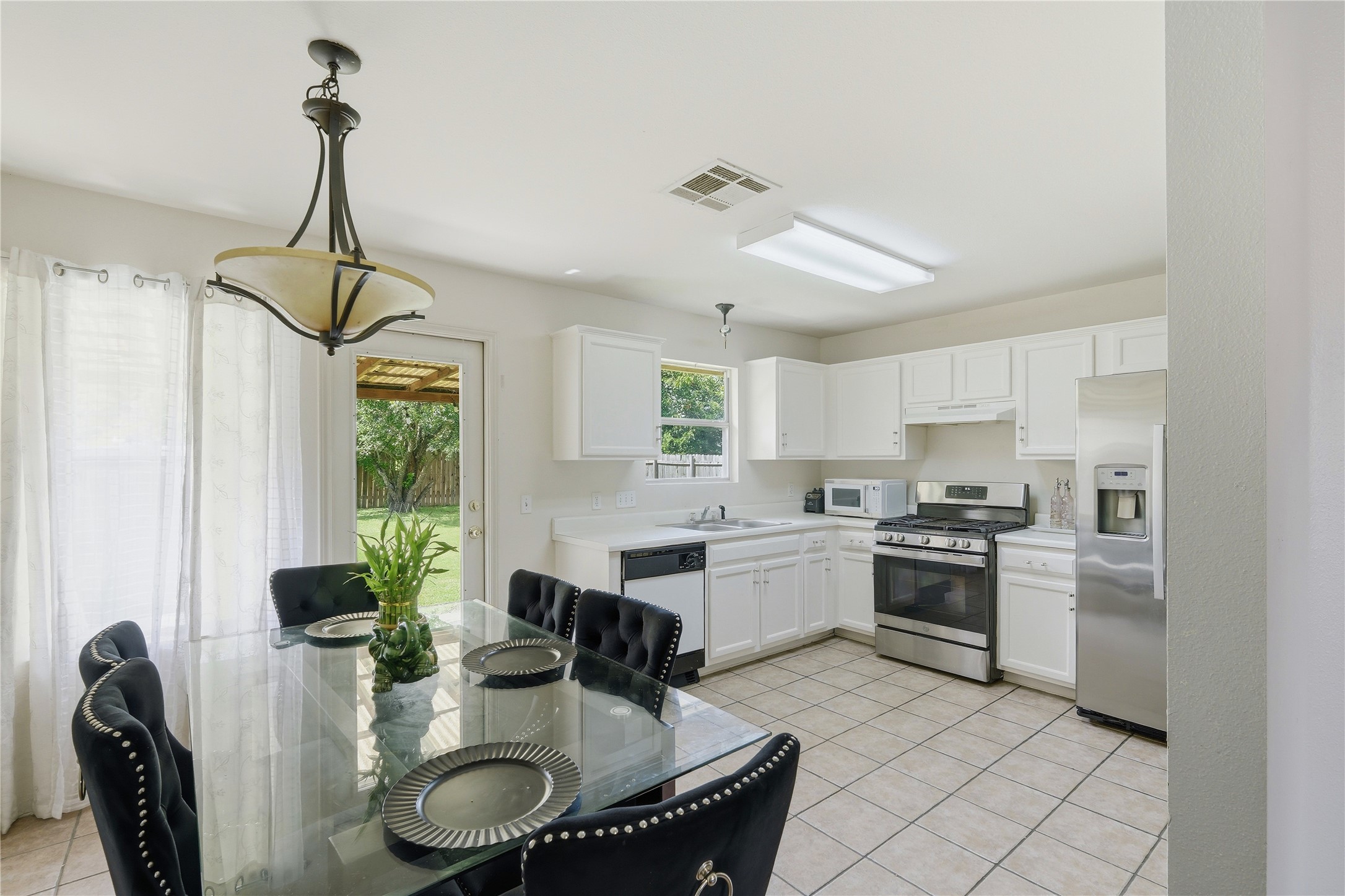 310 Raintree Drive Georgetown, TX 78626 - Photo 4 of 12 A well-equipped kitchen offers seamless access to outdoor living, perfect for entertaining.