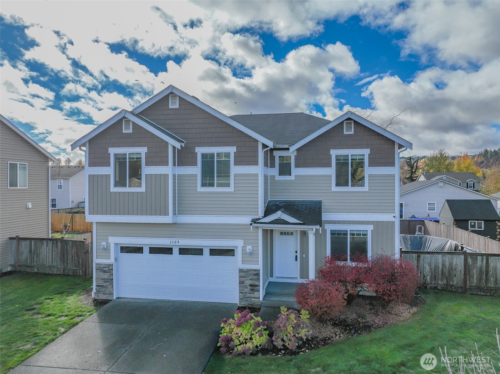 1105 Sigafoos Avenue Northwest Orting, WA 98360 - Photo 1 of 40 a front view of a house with garden