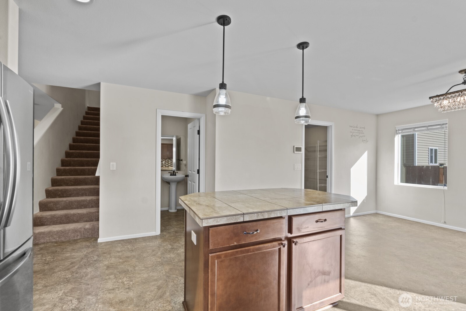 1105 Sigafoos Avenue Northwest Orting, WA 98360 - Photo 13 of 40 a kitchen with kitchen island sink and refrigerator