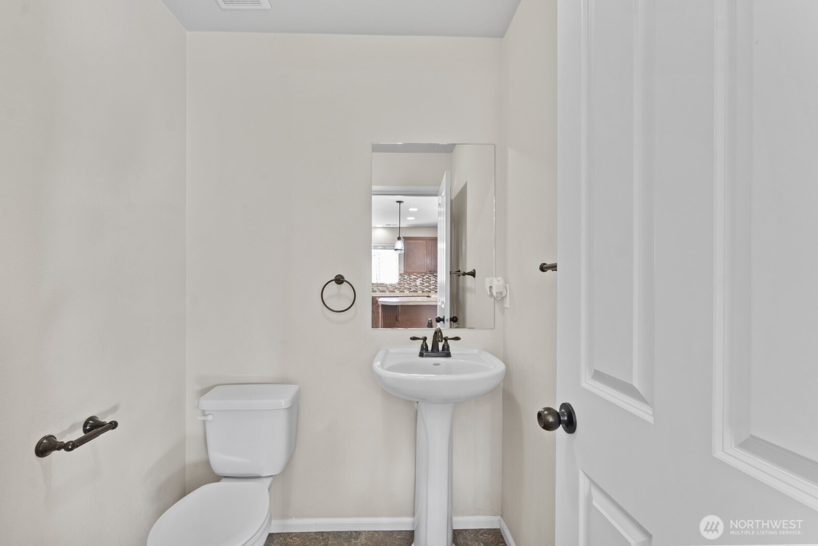 1105 Sigafoos Avenue Northwest Orting, WA 98360 - Photo 17 of 40 a bathroom with a toilet sink and mirror