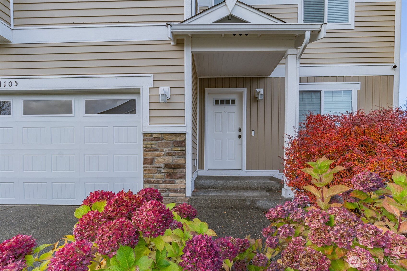 1105 Sigafoos Avenue Northwest Orting, WA 98360 - Photo 2 of 40 a front view of a house with flowers