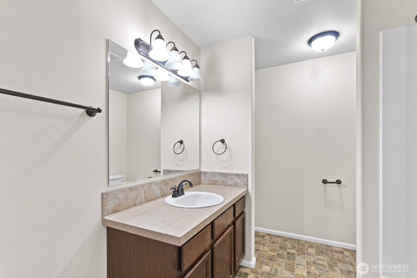 1105 Sigafoos Avenue Northwest Orting, WA 98360 - Photo 21 of 40 a bathroom with a sink and a mirror