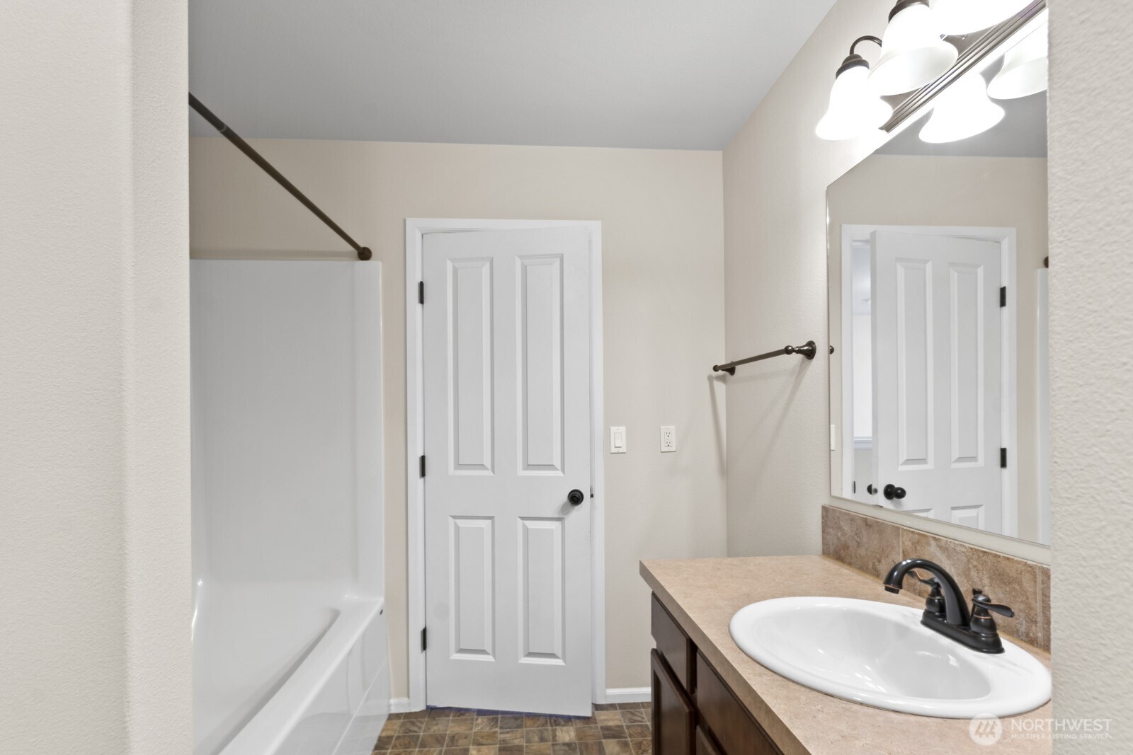 1105 Sigafoos Avenue Northwest Orting, WA 98360 - Photo 22 of 40 a bathroom with a sink a shower and a mirror