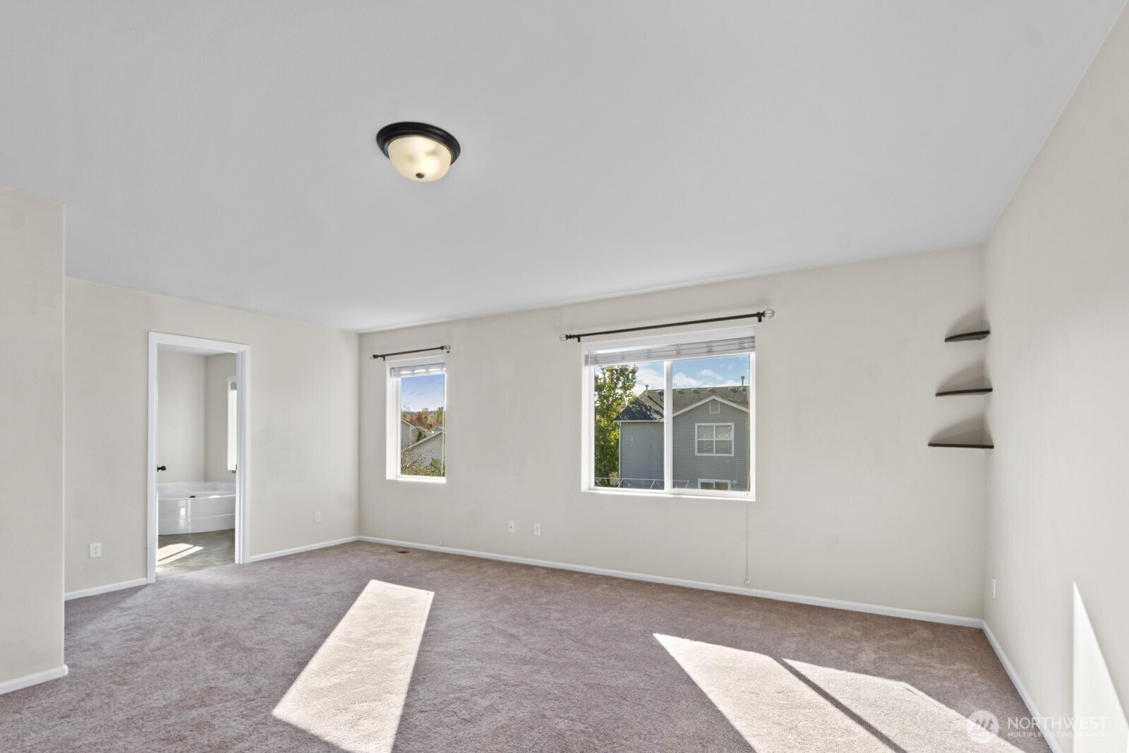 1105 Sigafoos Avenue Northwest Orting, WA 98360 - Photo 27 of 40 an empty room with windows and closet