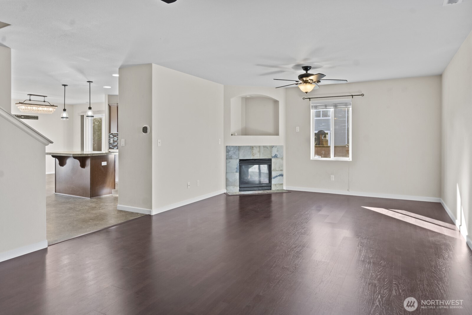1105 Sigafoos Avenue Northwest Orting, WA 98360 - Photo 7 of 40 a view of livingroom with hardwood floor and a kitchen