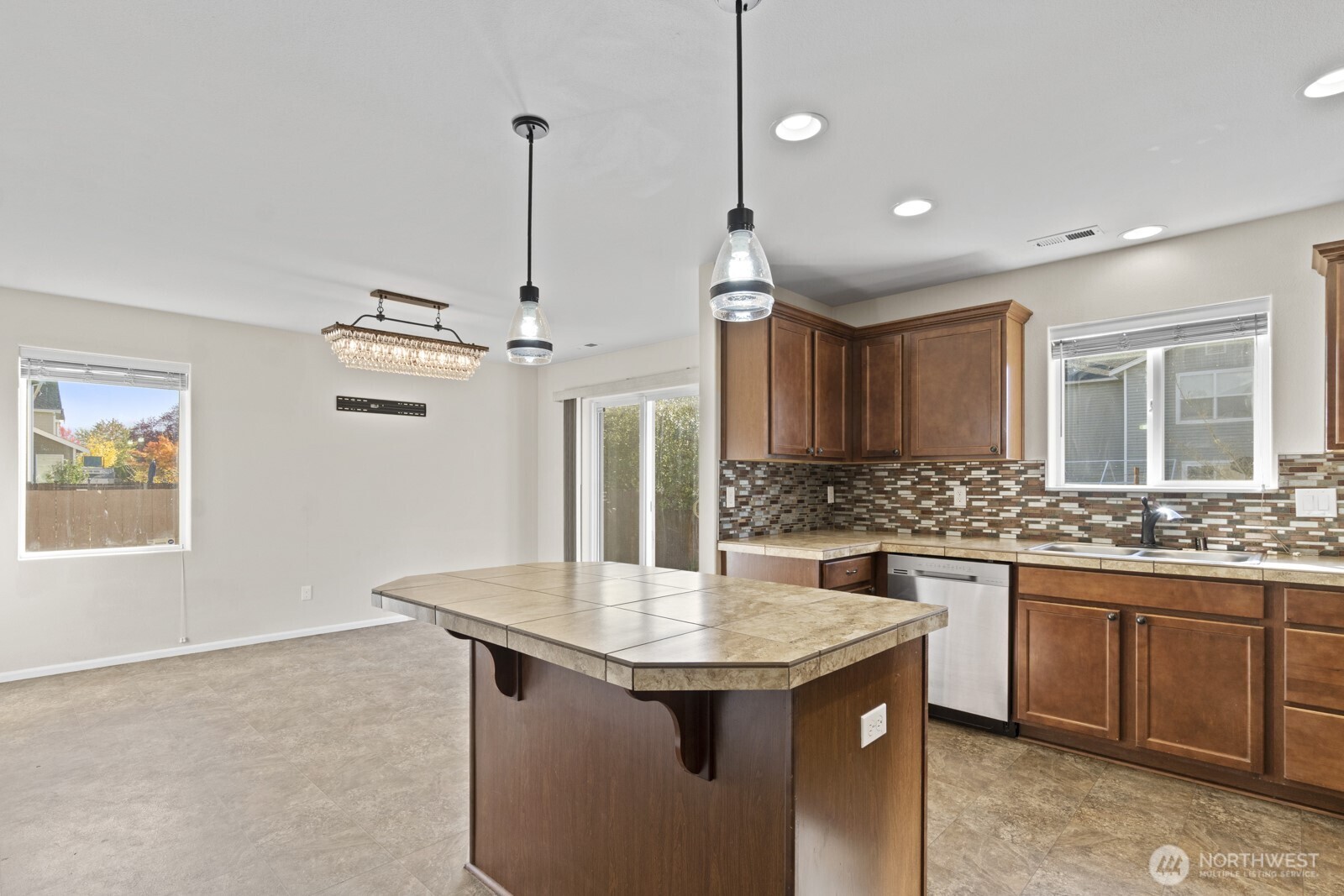 1105 Sigafoos Avenue Northwest Orting, WA 98360 - Photo 10 of 40 a kitchen with stainless steel appliances granite countertop stove a sink and a refrigerator