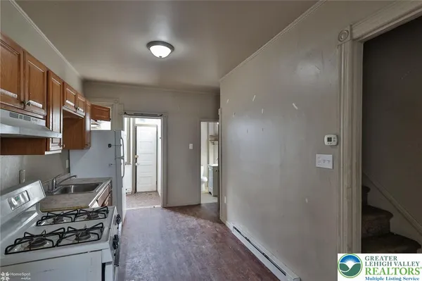 a kitchen with stainless steel appliances granite countertop a refrigerator and a stove top oven