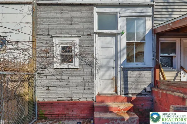 a brick building with a glass door