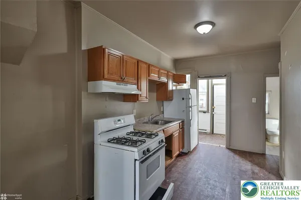 a kitchen with a stove and a refrigerator