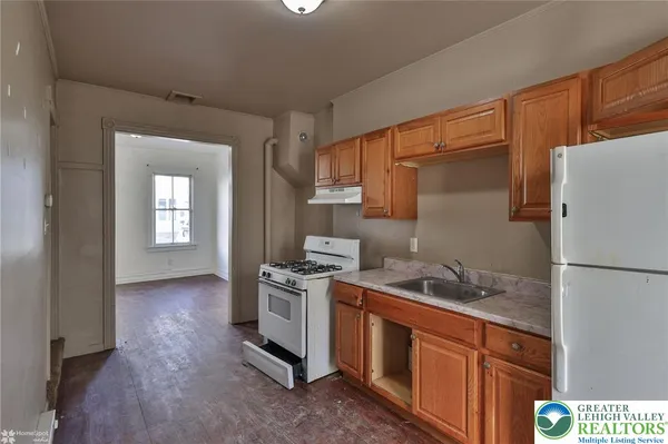 a kitchen with stainless steel appliances granite countertop a refrigerator a stove a sink and a microwave