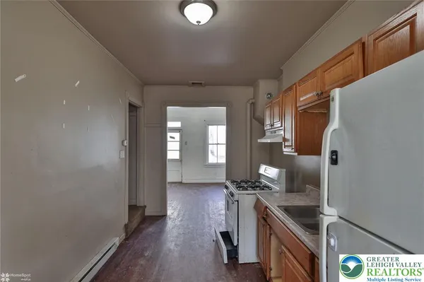 a kitchen with granite countertop a sink and cabinets