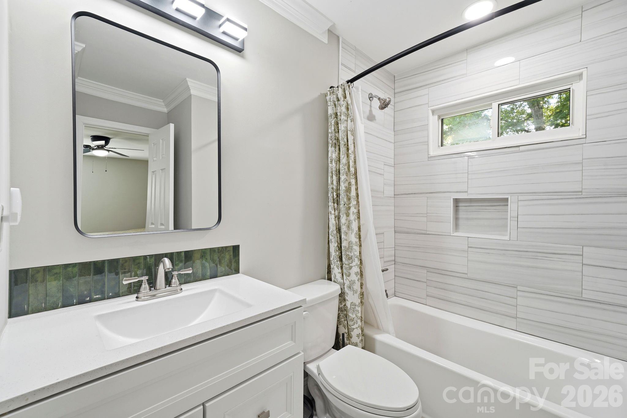 7552 Idlewild Road Charlotte, NC 28212 - Photo 8 of 40 a bathroom with a sink a toilet and shower