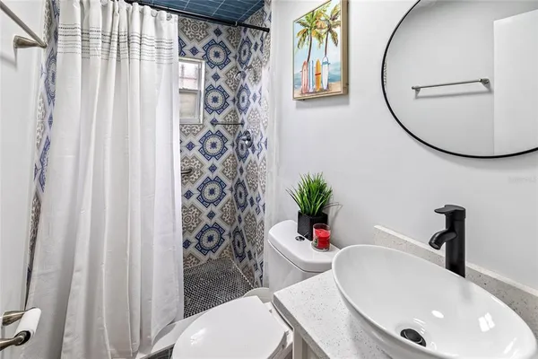 a bathroom with a sink toilet and a mirror