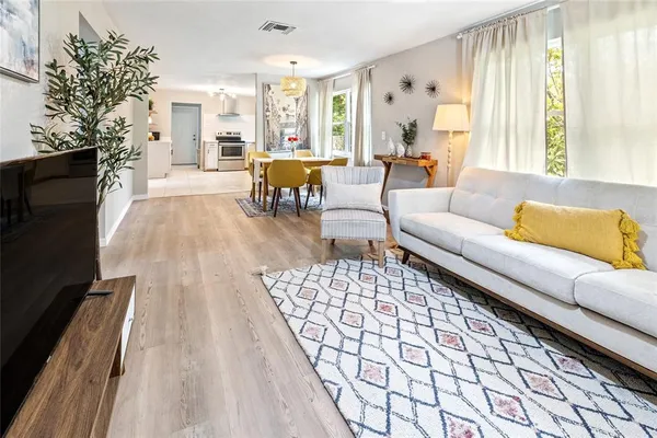 a living room with furniture fireplace and a large window