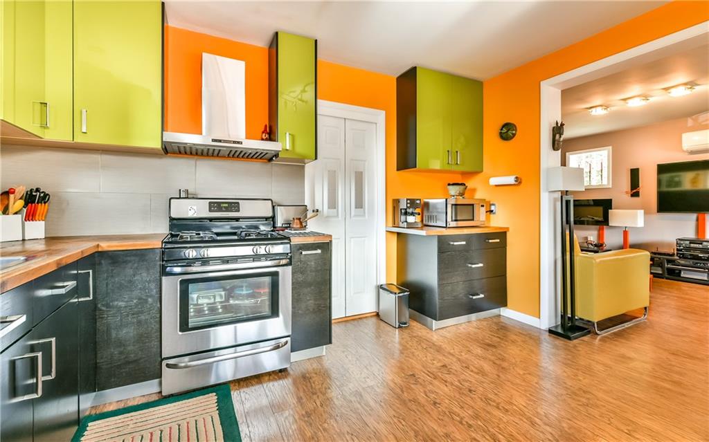 1022 Rothpletz Street Pittsburgh, PA 15212 - Photo 9 of 25 High end cabinetry with wooden countertops and stainless steel appliances.