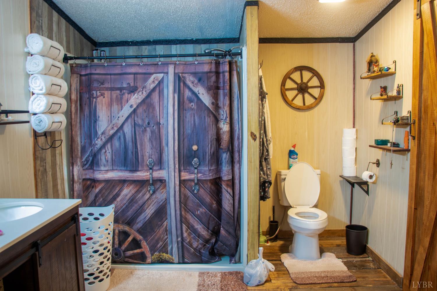 3156 Owens Mill Road Gretna, VA 24557 - Photo 16 of 31 a bathroom with a toilet and a shower curtain