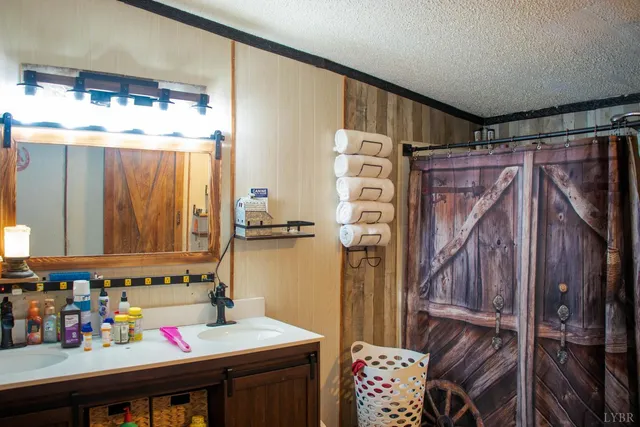 a bathroom with a toilet and a shower curtain