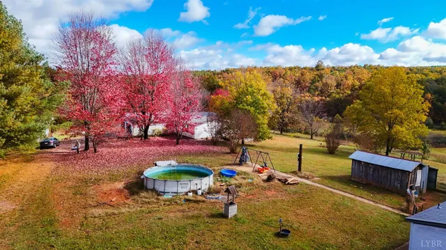 a view of a backyard with swimming pool