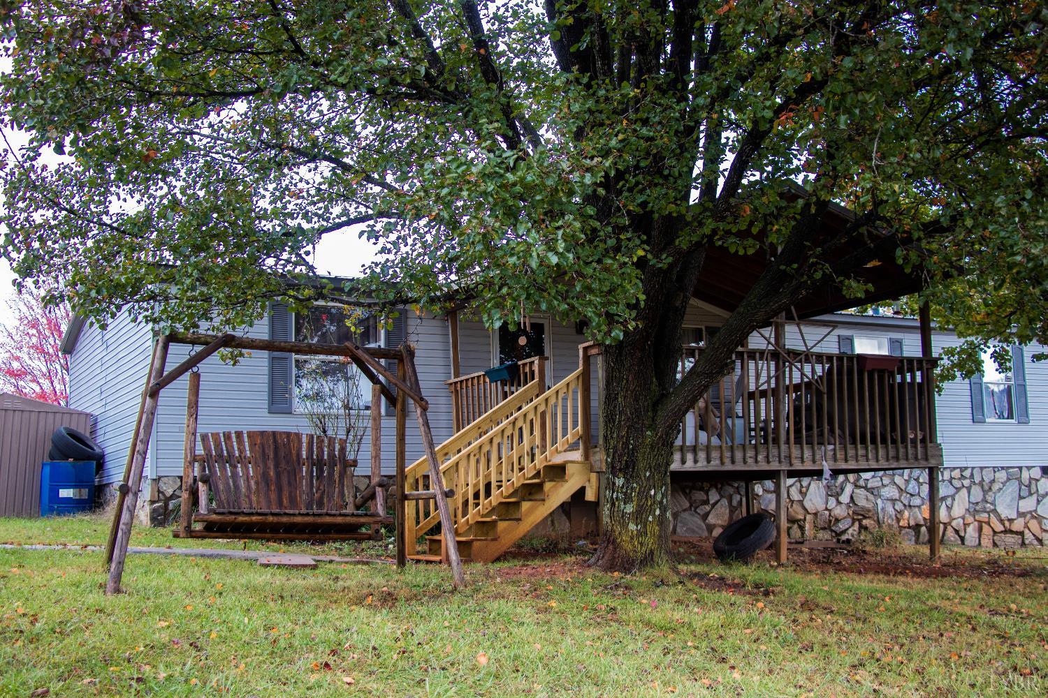 3156 Owens Mill Road Gretna, VA 24557 - Photo 22 of 31 a view of a house with a yard and a wooden deck