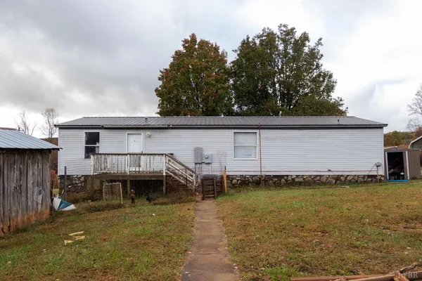 a view of a house with a garage and a car parked