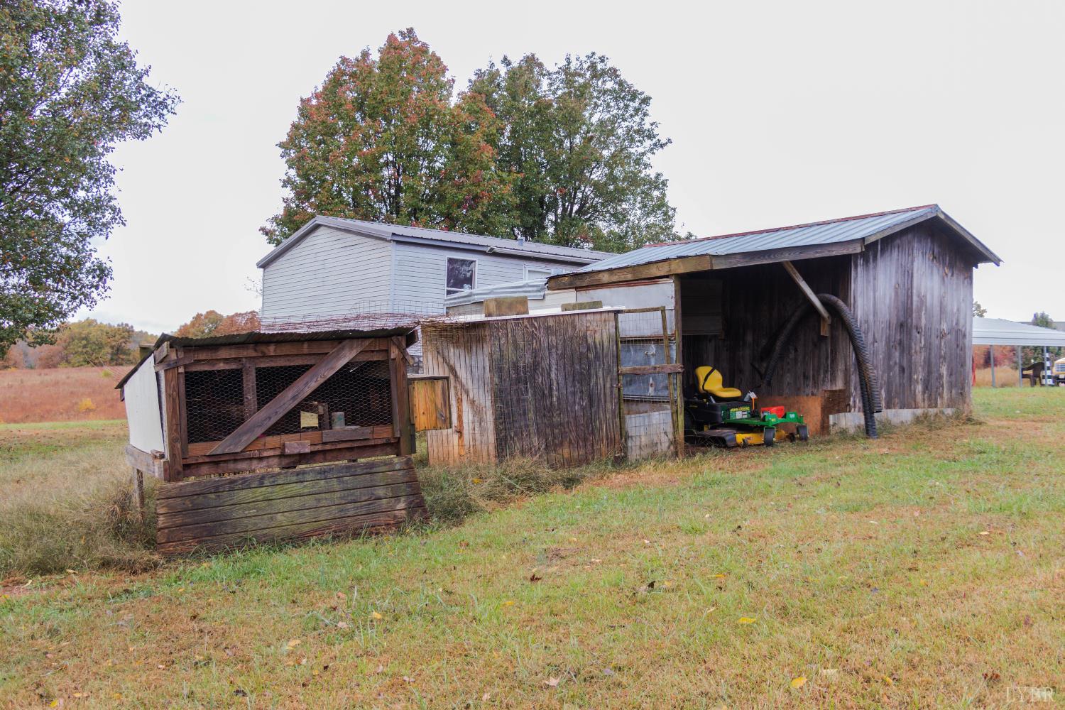 3156 Owens Mill Road Gretna, VA 24557 - Photo 24 of 31 a view of a house with a garage and a car parked