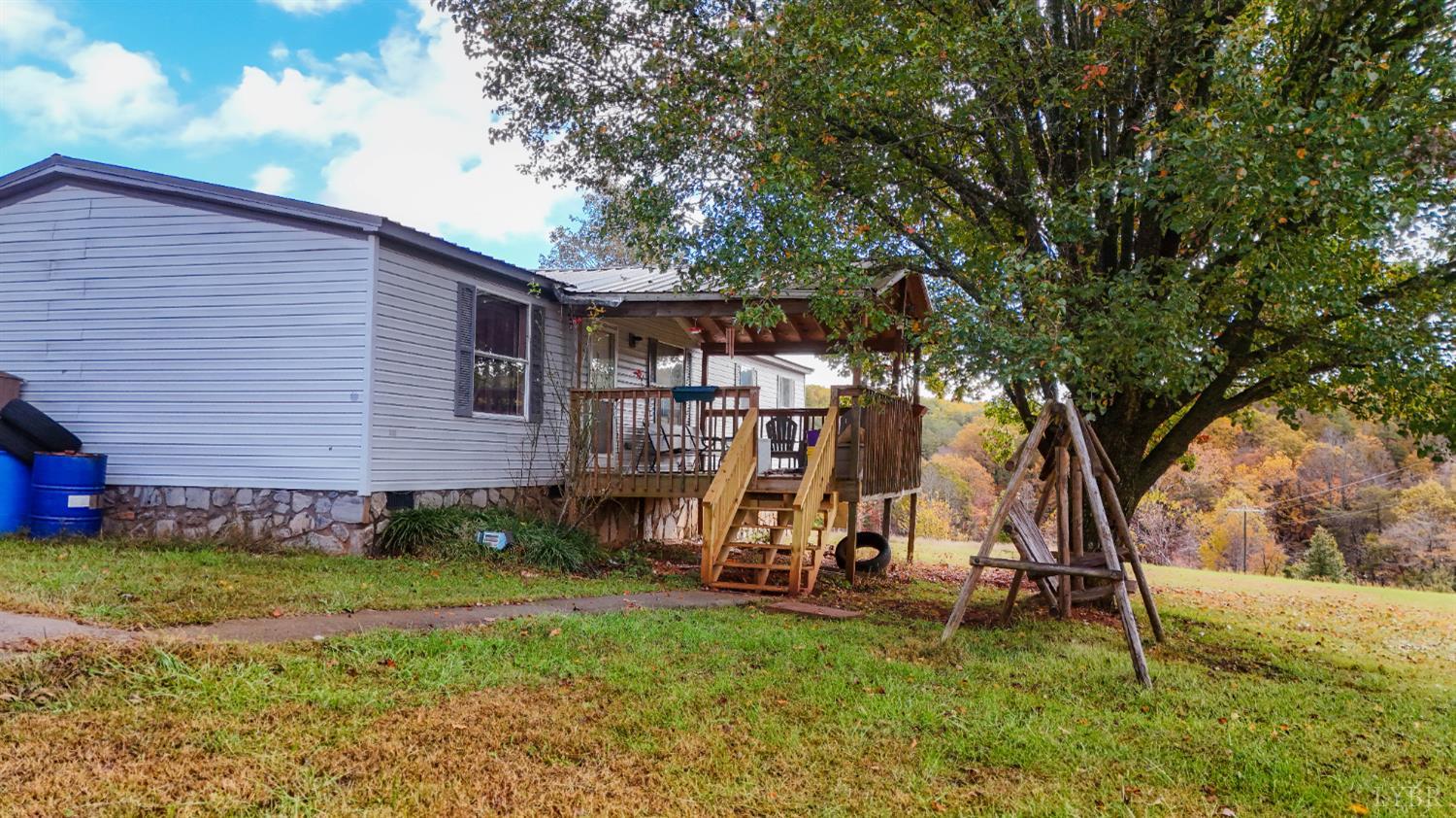 3156 Owens Mill Road Gretna, VA 24557 - Photo 8 of 31 a view of backyard with a table and chairs and a large tree