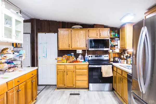 a kitchen with a stove a sink and a microwave