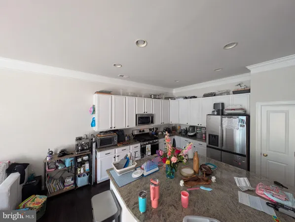a kitchen with sink refrigerator and microwave